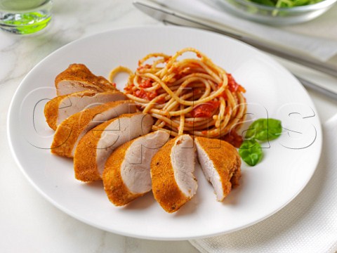 Wholewheat spaghetti Napolitana with chicken in breadcrumbs