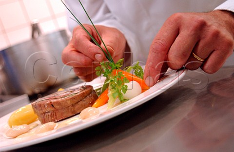chef arranging food on a plate
