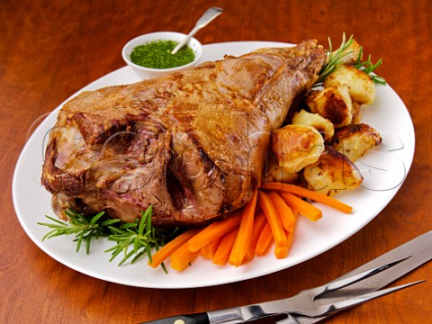 Roast leg of lamb with vegetables and mint sauce