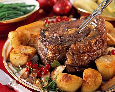 Roast beef with roast potatoes in a festive table setting