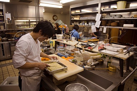 Chef with herb butter in Japanese restaurant kitchen