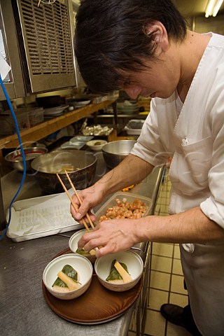 Preparing minced prawns and sticky rice wrapped in a sakura cherry leaf in a Japanese restaurant kitchen