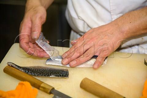 Removing the skin from a mackerel fillet to be used for sushi