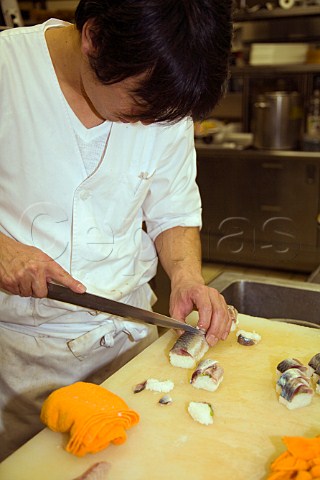 Cutting mackerel sushi in a Japanese restaurant