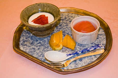 Japanese dessert strawberries in coconut yoghurt tomato and orange slices
