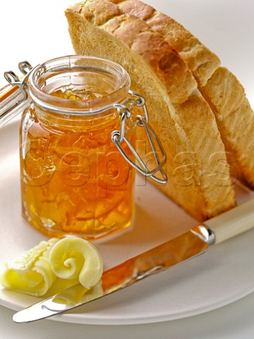 Toasted white bread with curls of butter and marmalade