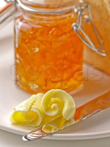 Toasted white bread with curls of butter and marmalade