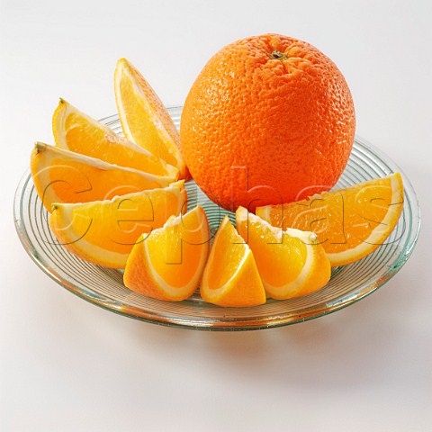 Whole orange with segments on a plate