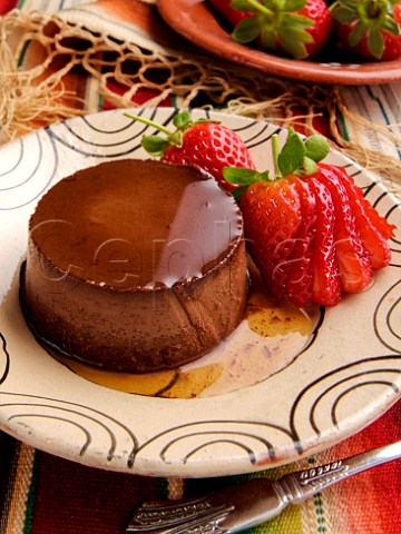 Plate of Mexican chocolate crme caramel with fresh strawberries