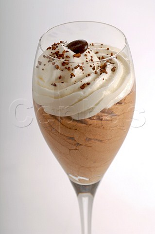 Mocha mousse and cream dessert served in a wine glass
