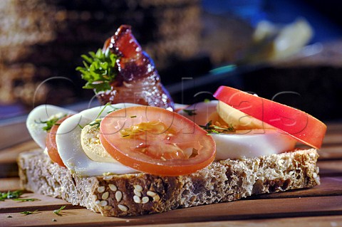 Bacon boiled egg and tomato open sandwich