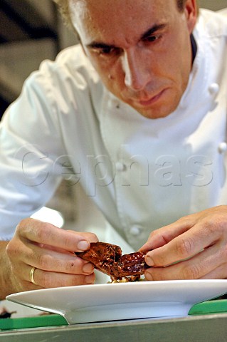 Chef arranging food on a plate