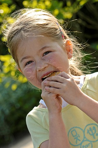 Young girl enjoying bread roll