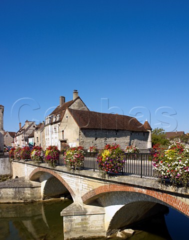 Colourful flower boxes decorate the bridge over the Serein River in the wine town of Chablis Yonne France