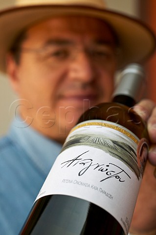 Christos Anagnostou of Anagnostou Winery holding a bottle of retsina Koropi Greece Attica