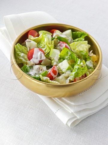 Apple and tomato salad with sunflower seeds and caesar salad dressing
