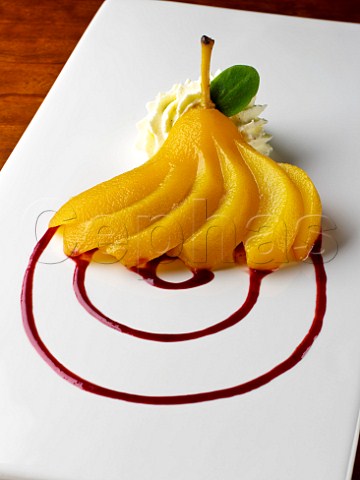 Poached pear with raspberry coulis