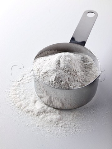 Selfraising flour in a steel measuring cup