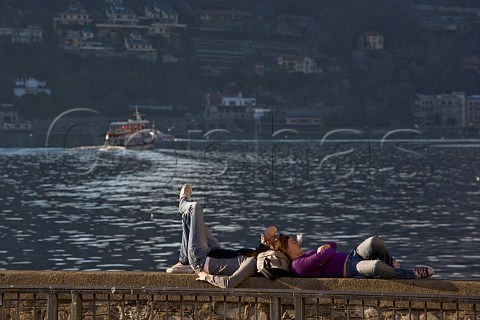 Two girls relaxing by Lake Como Lombardy Italy