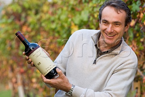 Franco Massolino holding a bottle of his Vigna Rionda Barolo wine in Vigna Rionda vineyard Serralunga dAlba Piemonte Italy Barolo
