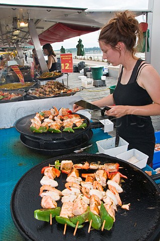 Cooking seafood kebabs on a market stall at Quai des Chartrons Bordeaux Gironde France