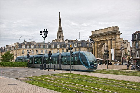 City tram passing the Porte de Bourgogne on Quai des Salinires with the spire of the church of StMichel behind  Bordeaux Gironde France