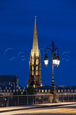 The spire of the church of StMichel and lights of Pont de Pierre at night Bordeaux Gironde France