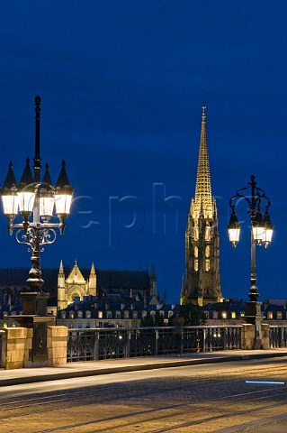 The spire of the church of StMichel and lights of Pont de Pierre at night  Bordeaux Gironde France