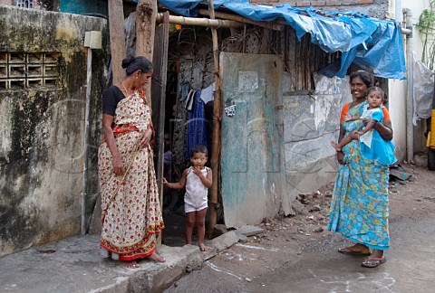 Indian women and children outside their homes Thiruvalluvar Nagar Ayanavaram Chennai Madras India