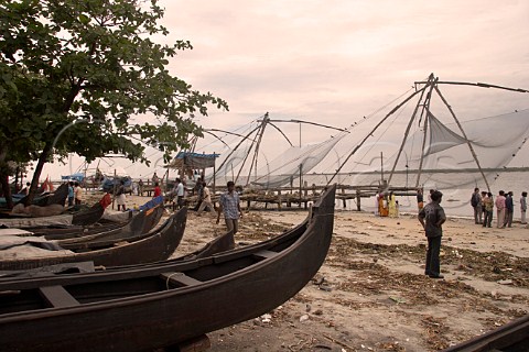 Boats and Chinese fishing nets line the northern shore of Fort Cochin Kochi Cochin Kerala India