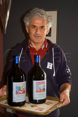 Roberto Voerzio with magnum bottles of his Barolo and Barbera dAlba in his tasting room La Morra Piemonte Italy