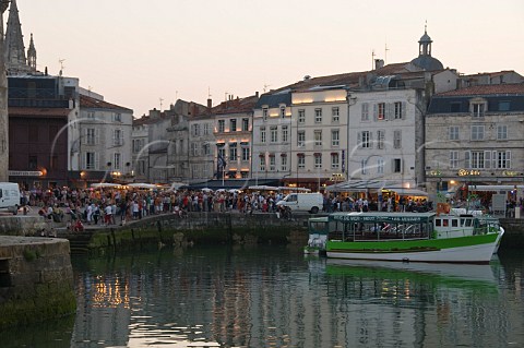 Crowds by the harbour on a summer evening La Rochelle CharenteMaritime France