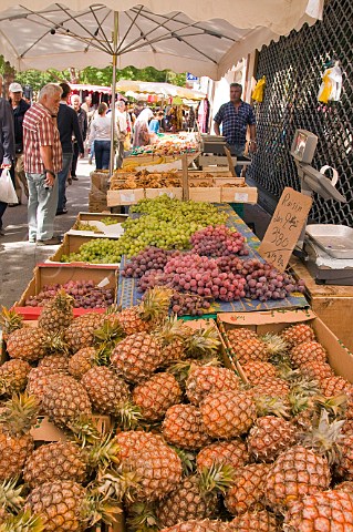 Pineapples and grapes on sale at the Sunday market in LIslesurlaSorgue Vaucluse Provence France