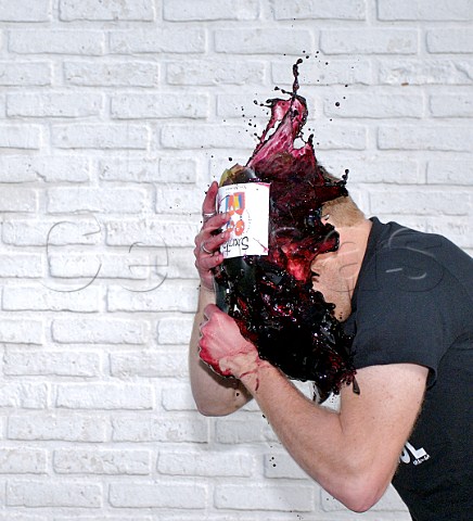 Winemaker Grant Phelps smashing bottle of red wine on his head  Chile