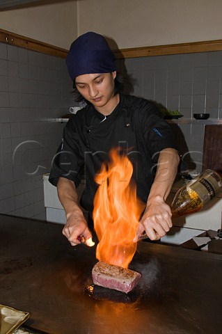 Flambing fillet steak at the table Miyama Japanese restaurant City of London