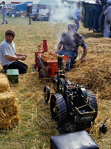 2 scale model of agrucultural traction engine and Ransomes Threshing machine at the Great Dorset Steam Fair  Dorset England