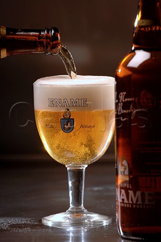 Pouring glass of Ename Belgian beer