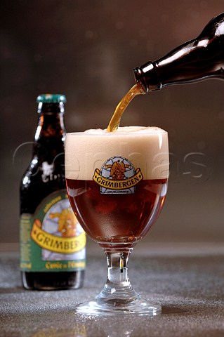 Pouring glass of Grimbergen Belgian beer