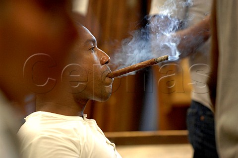 Man smoking cigar at Partagas  Havana Cuba