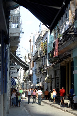 People walking in cobbled street  Havana Cuba