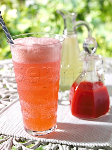 A glass of sparkling raspberry soda