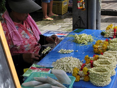 Stall selling flower wristbands at a Bangkok street market Thailand