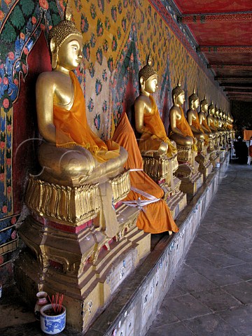 Row of golden buddhas Wat Arun Bangkok Thailand