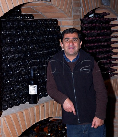Marcelo Retamal winemaker of De Martino with bottle of his El Len Carignan  Maule Chile