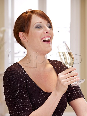 Young woman drinking glass of Champagne