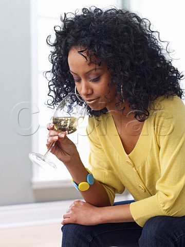 Young woman drinking glass of white wine