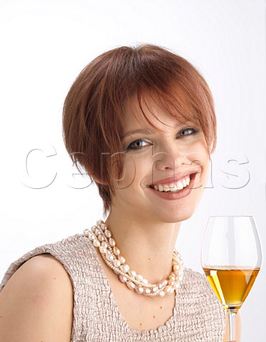 Young woman drinking glass of ice wine