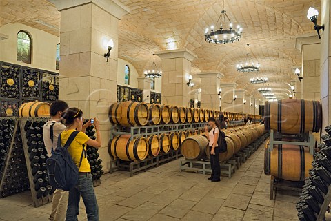 Tourists taking photographs in barrel cellar at Chateau Changyu AFIP Global winery Ju Gezhuang Beijing Miyun County China