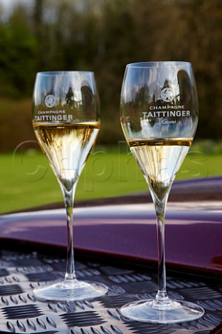 Glasses of Champagne on the bonnet of a Land Rover to drink prior to launching of the Taittinger hotair balloon
