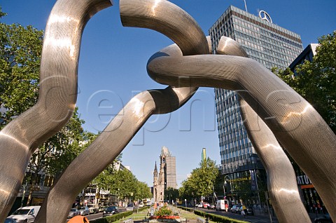 One of many modern sculpture displays along the Kurfurstenstrasse with the Kaiser Wilhelm Gedachtniskirche in the distance Berlin Germany
